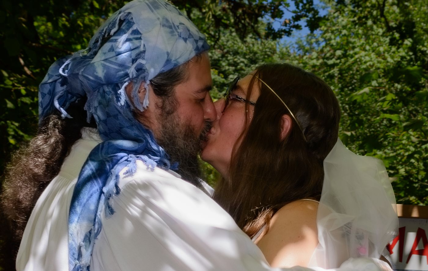 Sharing a kiss beneath the veil