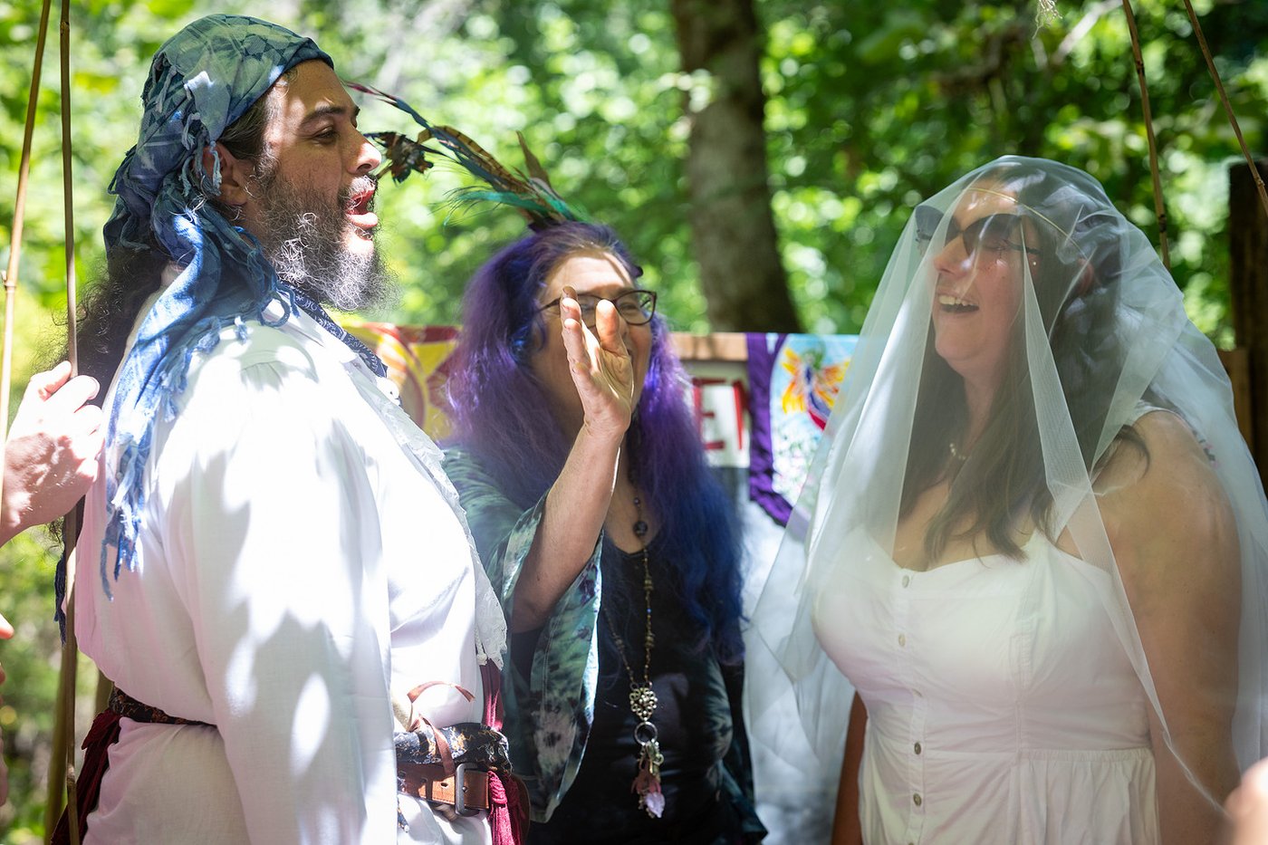 Laughing beneath the veil during the ceremony