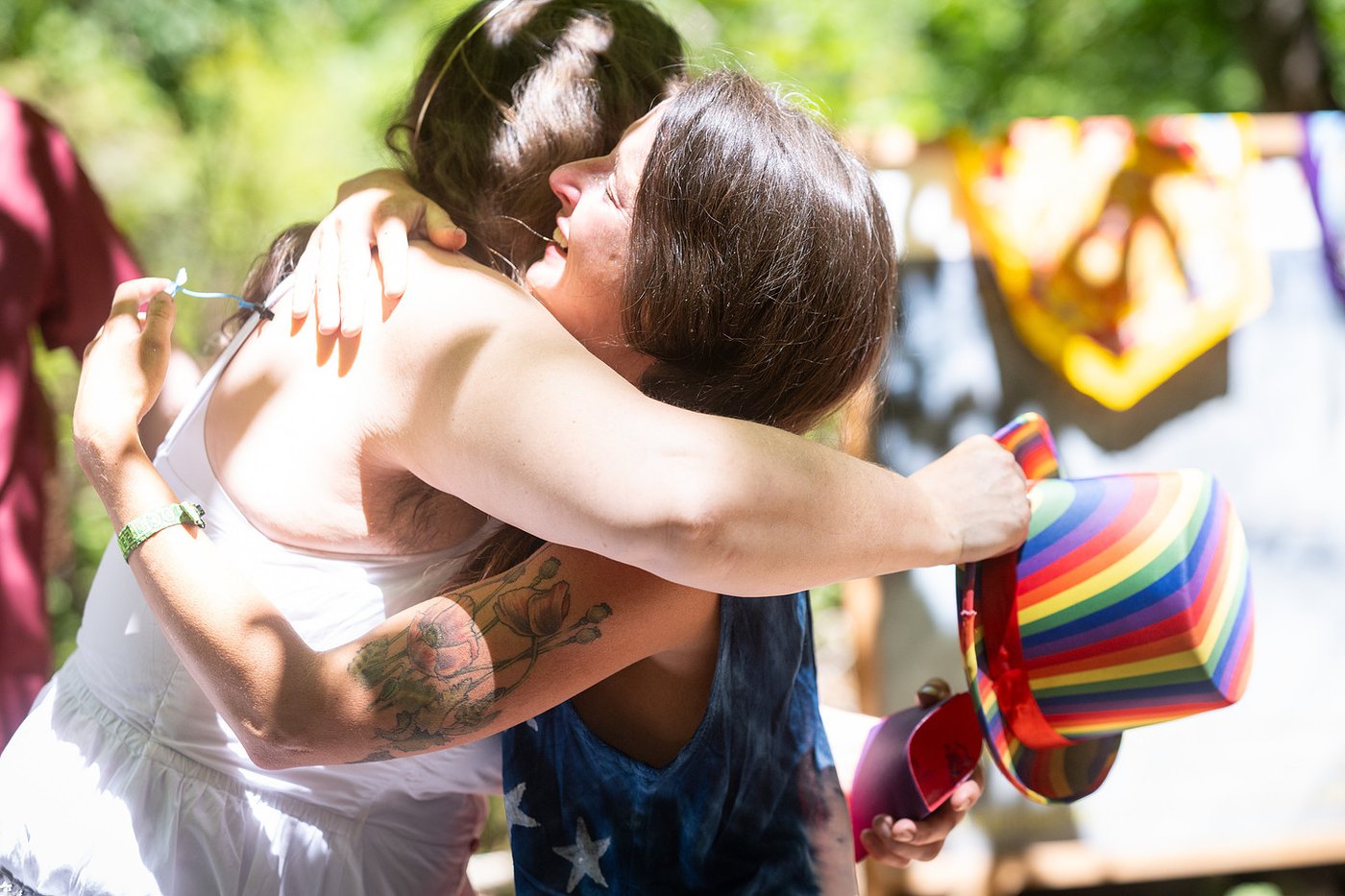 A rainbow-hatted bear hug