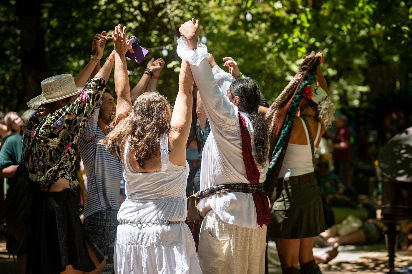 The circle dance, hands raised high